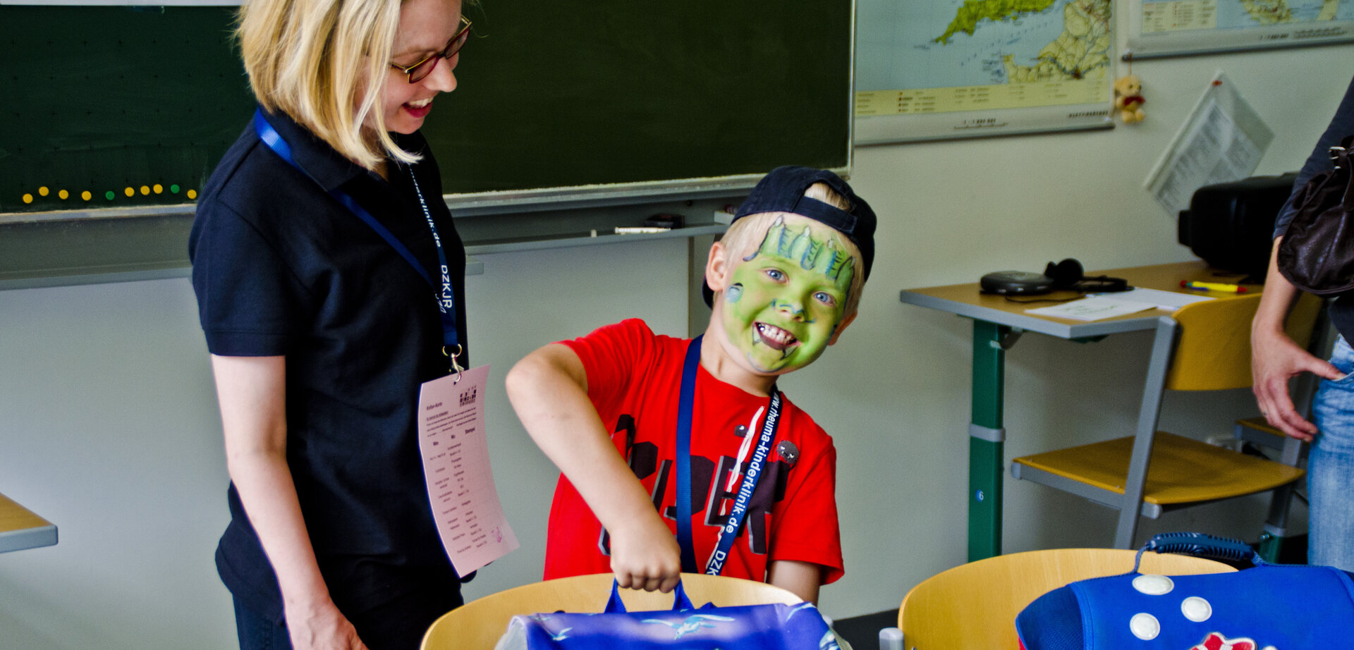 Als Monster geschminktes Kind mit Lehrerin